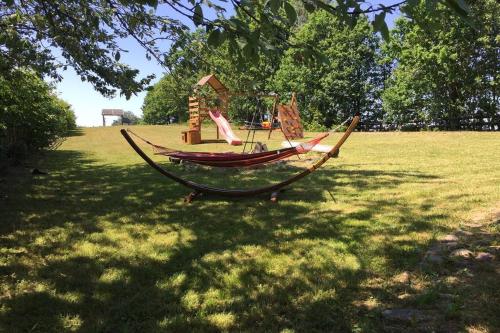 a hammock in a field with a playground at Widokówka Kaszuby in Mirachowo