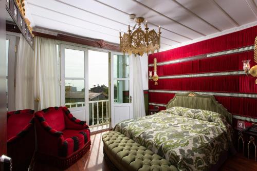 a bedroom with red walls and a bed and a chair at Premist Hotels Sultanahmet in Istanbul