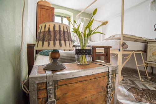 a lamp on top of a wooden chest in a bedroom at Nomi Dream Box in Split
