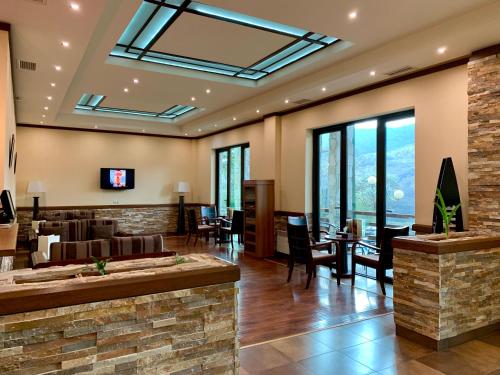 a lobby with a couch and a table and chairs at Dilijan Park Resort & Villas in Dilijan