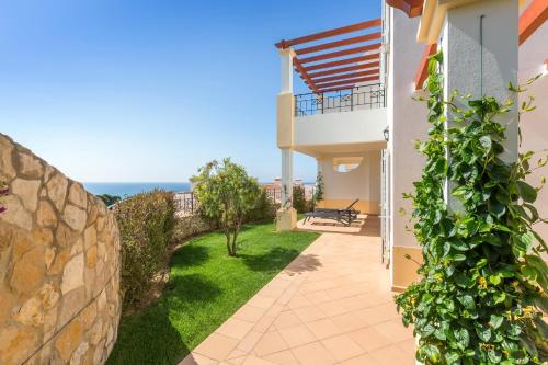 a view from the balcony of a house with a garden at NAU Salema Beach Village in Salema