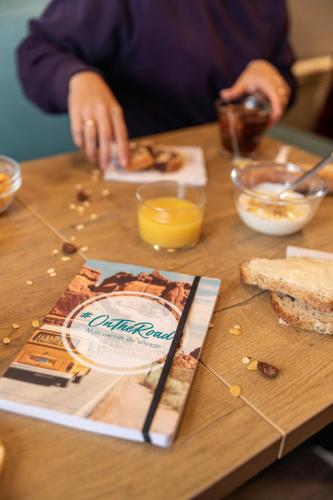 a person making food on a table with a book at hotelF1 Lille Villeneuve d'Ascq in Villeneuve d'Ascq