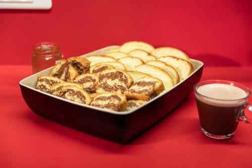 a tray of pastries on a red table with a glass of coffee at hotelF1 Lille Villeneuve d'Ascq in Villeneuve d'Ascq