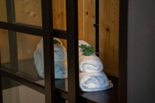 two bundles of towels sitting on a shelf at Casa Domestic, Modern Guest House in Viştea de Sus