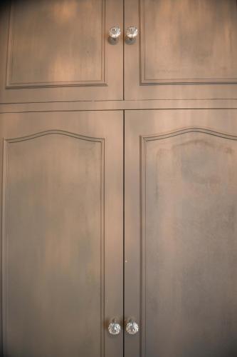 a set of wooden cabinets with silver handles at Hotel du Commerce in Amou
