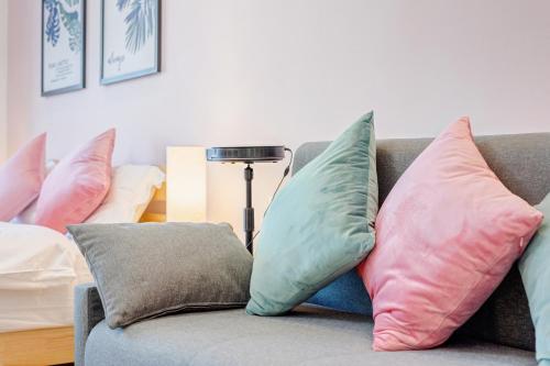 a bunch of pillows sitting on a couch at Lavender Apartment in Guangzhou