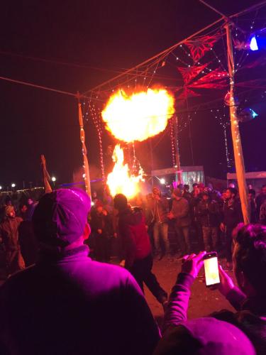 a crowd of people watching a fire show at night at Kabila Camp in Kasol