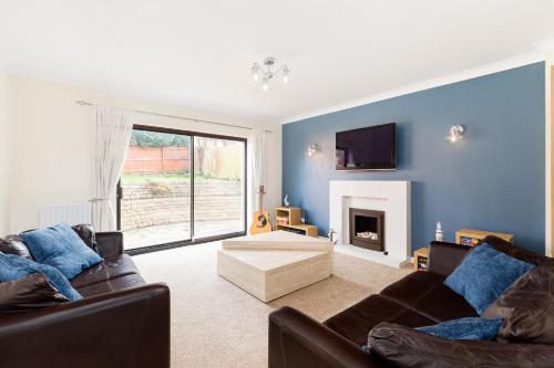 a living room with two couches and a fireplace at Drayton Manor House FREE parking in Tamworth