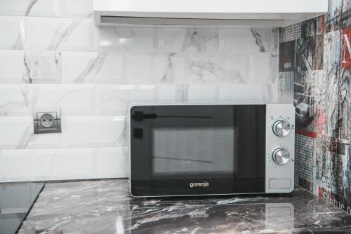 a microwave oven sitting on a counter in a kitchen at Апартаменти в центрі Львова in Lviv