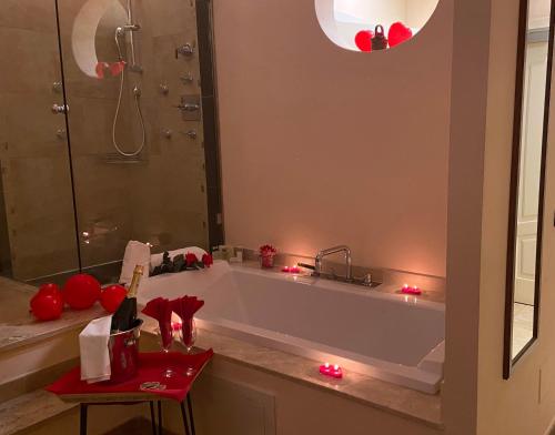 a bathroom with a tub and a shower with red lights at Vogue Hotel Arezzo in Arezzo