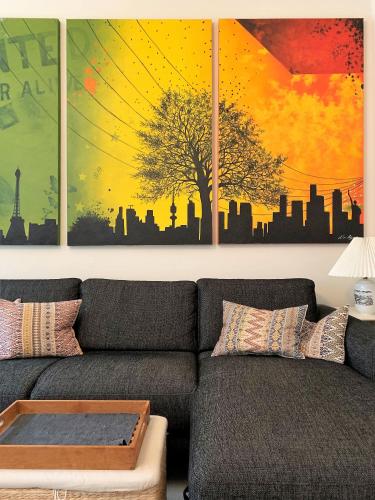 a living room with a couch and a painting at ApartmentInCopenhagen Apartment 1436 in Copenhagen