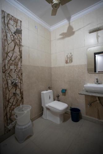 a bathroom with a toilet and a sink at Hotel Yes Boss International- Awarded Best Hotel 2025 in Budget Category in New Delhi