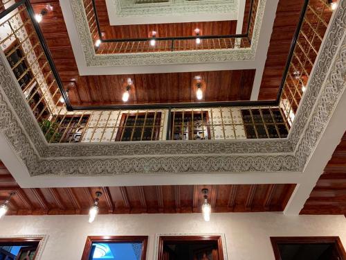 a coffered ceiling in a building with windows at Riad Dar El Mesk in Rabat