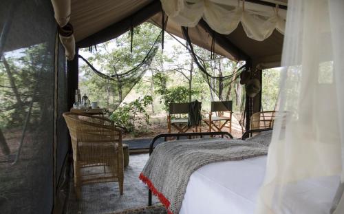 a bedroom in a tent with a bed at Simbavati Trails Camp in Timbavati Game Reserve