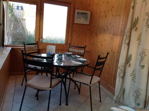 a dining room with a table and four chairs at Moraydale Guest House in Elgin