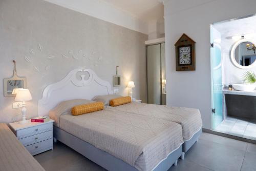a bedroom with a large bed and a bathroom at Blue Sea Hotel in Kamari