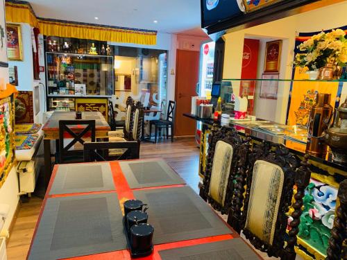 a restaurant with a bar with a table and chairs at Swiss Dewa in Luzern