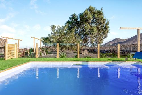 
a pool with a pool table and chairs in it at Villa Tranquila in Villaverde
