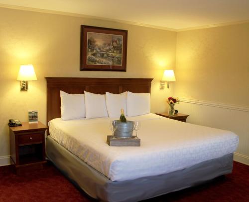 a hotel room with a large bed and two lamps at SHERWOOD MOTEL in Wellsboro