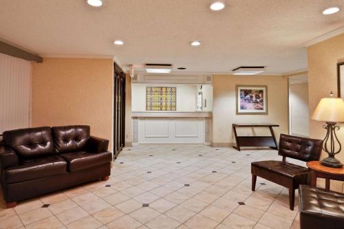 a lobby with two leather chairs and a waiting room at La Quinta by Wyndham Tampa Fairgrounds - Casino in Tampa