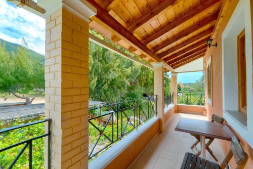 a balcony with a table and a bench on it at Christinas lofts in Ágios Matthaíos
