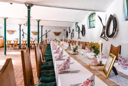 a row of tables in a room with green chairs at Historische Spitzgrundmühle in Coswig