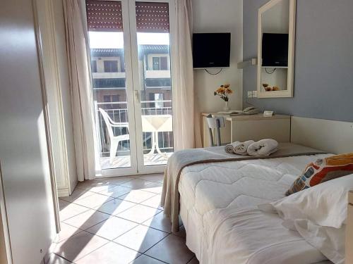 Säng eller sängar i ett rum på Hotel Garnì Anna