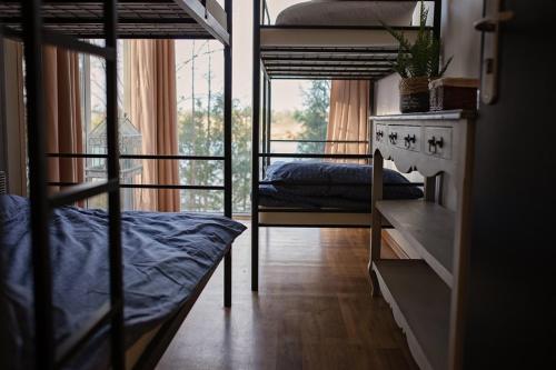 a room with two bunk beds and a desk at Zakątek Nad Jeziorem in Łyśniewo