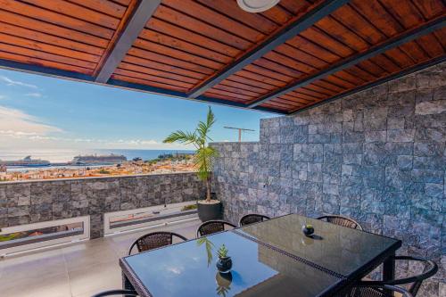 a dining room with a table and a view of the ocean at Flowers Island house 2 in Funchal