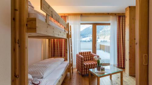 Camera con letto a castello e sedia di Family Resort Rainer a Sesto