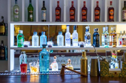a bar with a lot of bottles of alcohol at Dorisol Mimosa Studio Hotel in Funchal