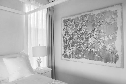 a bedroom with a bed and a painting on the wall at West Rock Villas in Saint James