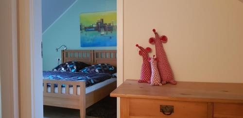 a bedroom with a bed and a wooden dresser at Weingut Schunck in Leinsweiler