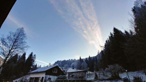 a view of a snow covered mountain with a house at Apartment MASCH in Arriach