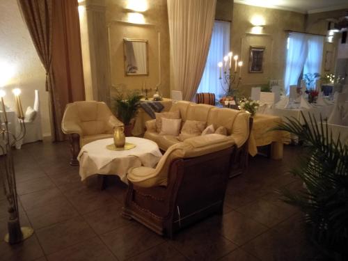 a living room with a couch and a table at Hotel Polak in Zamość