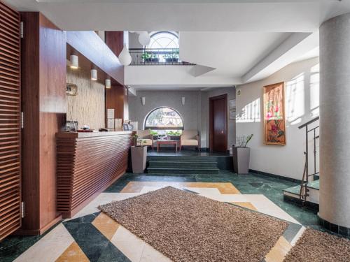 a lobby with a reception desk and a table at Hotel Miruna - New Belvedere in Poiana Brasov