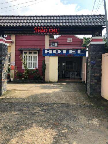 a red building with a hotel sign on it at Thảo Chi in Bao Loc