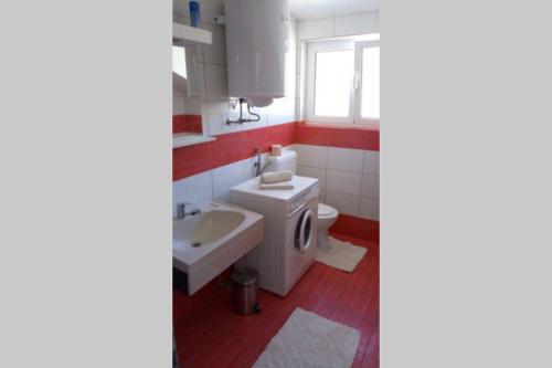a bathroom with a toilet and a sink at Apartment Jope in Kaštela