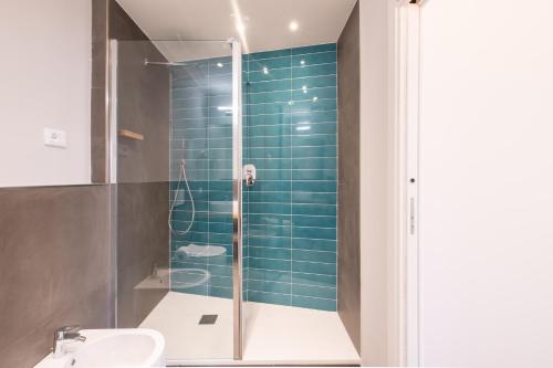 a bathroom with a glass shower and a sink at Torri & Portici in Bologna
