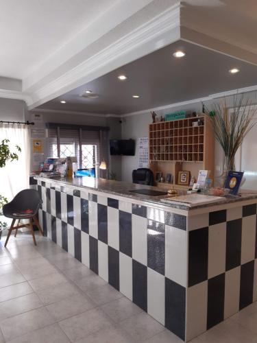 a kitchen with a black and white checkered counter at Hotel Cano in Torrevieja