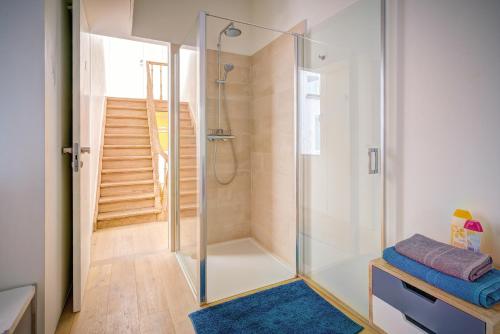 a glass shower in a bathroom with a staircase at The Bright Stone Lodge. Heart of Antwerp in Antwerp