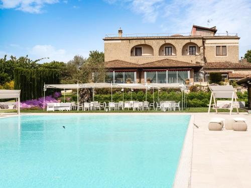 a villa with a swimming pool in front of a house at Tenute del Gheppio in Dugenta