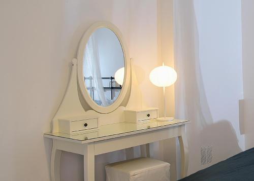 a white dressing table with a mirror on it at Hotel Rio Piedra in Nuévalos