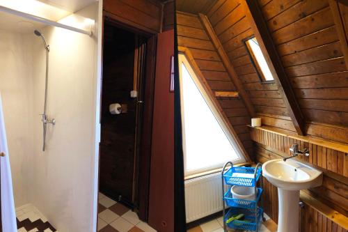 a bathroom with a sink and a window at Domki Brda in Karpacz