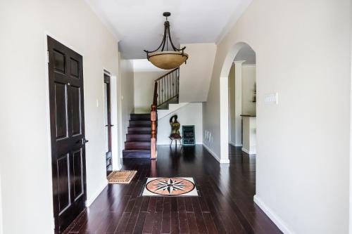 a hallway of a home with a door and a rug at Blue Paloma Bed & Breakfast in Lucea