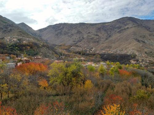 a town in a valley with mountains in the background at Riad Atlas Imlil in Imlil