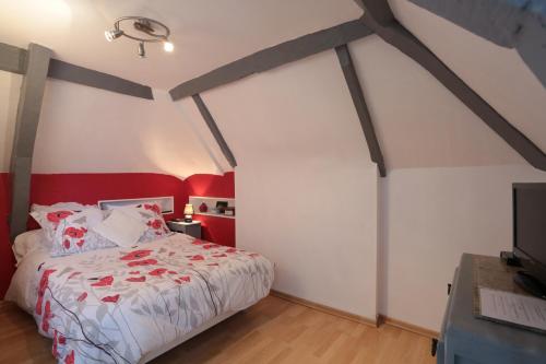 1 dormitorio con paredes rojas y blancas y 1 cama en Restaurant & Chambres d'Hôtes L'Eau Vive, en Fatouville-Grestain