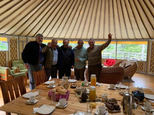 a group of men standing around a table in a tent at Fundo Panguilemu in Coihaique