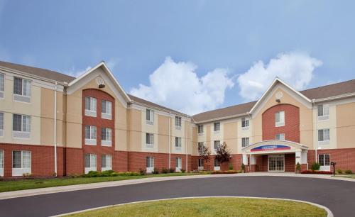 an exterior view of a building with a circular driveway at Candlewood Suites Kansas City by IHG in Kansas City