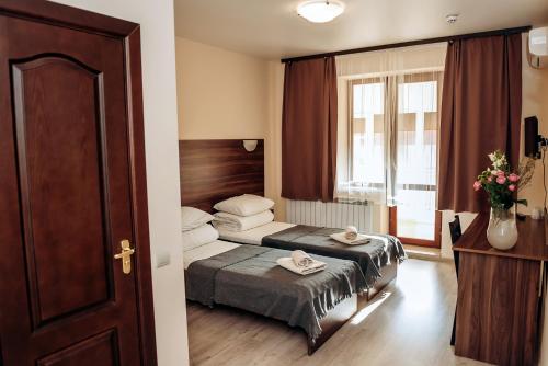 ein Hotelzimmer mit einem Bett und einem Fenster in der Unterkunft Villa Kmeller in Lwiw
